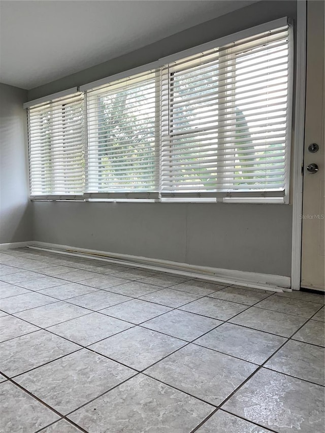 tiled empty room with baseboards