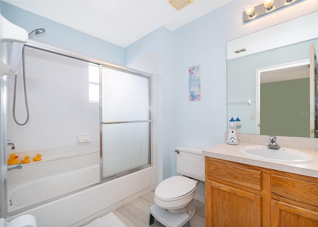 979 Park Terrace Cir, Kissimmee, FL 34746 - full bath featuring vanity, shower / bath combination with glass door, toilet, and visible vents