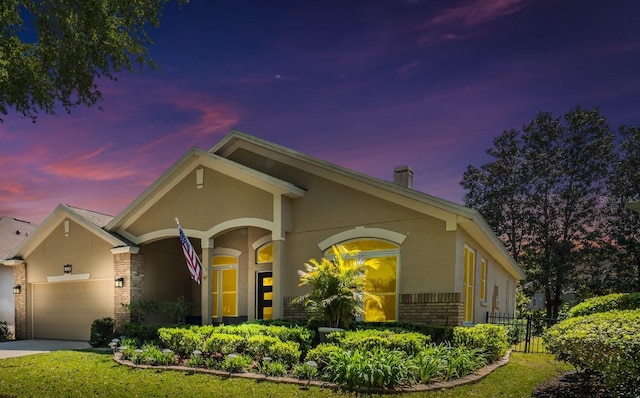 1450 Chessington Cir, Lake Mary, FL 32746 - view of front of home featuring brick siding, driveway, fence, and stucco siding
