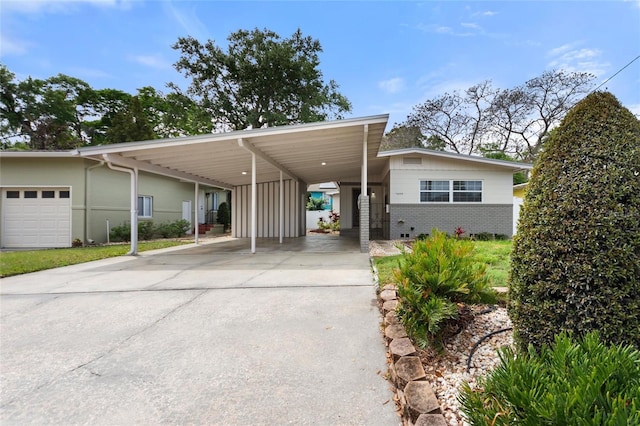 view of front of home with an attached carport and concrete driveway
