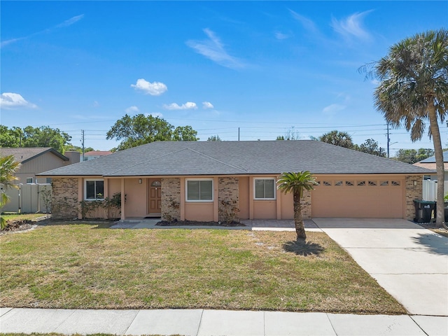 8720 Larwin Ln, Orlando, FL 32817 - ranch-style home featuring fence, roof with shingles, an attached garage, driveway, and a front yard