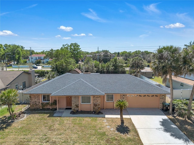 8720 Larwin Ln, Orlando, FL 32817 - single story home featuring a front yard, concrete driveway, stucco siding, a shingled roof, and a garage