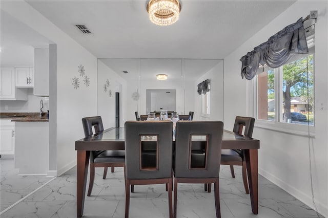 8720 Larwin Ln, Orlando, FL 32817 - dining room with marble finish floor, baseboards, and visible vents