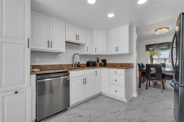 8720 Larwin Ln, Orlando, FL 32817 - kitchen featuring dishwasher, marble finish floor, dark stone counters, and freestanding refrigerator