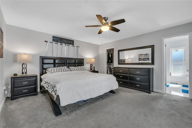 8720 Larwin Ln, Orlando, FL 32817 - carpeted bedroom with a closet, ensuite bathroom, baseboards, a ceiling fan, and a walk in closet