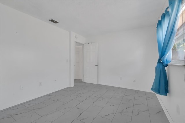 8720 Larwin Ln, Orlando, FL 32817 - spare room featuring marble finish floor, baseboards, and visible vents