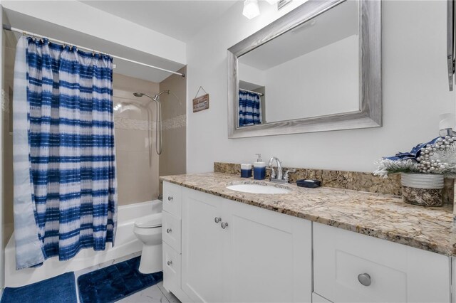8720 Larwin Ln, Orlando, FL 32817 - bathroom featuring marble finish floor, toilet, vanity, and shower / tub combo