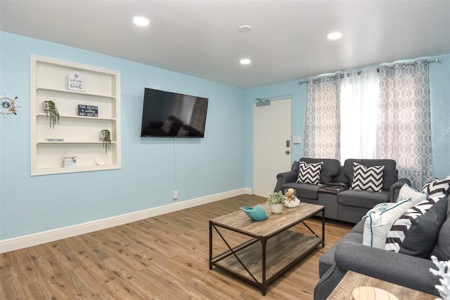 103 Mason Park Dr, Daytona Beach, FL 32117 - living room featuring recessed lighting, built in shelves, wood finished floors, and baseboards