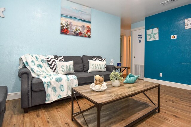 103 Mason Park Dr, Daytona Beach, FL 32117 - living room with visible vents, baseboards, and wood finished floors
