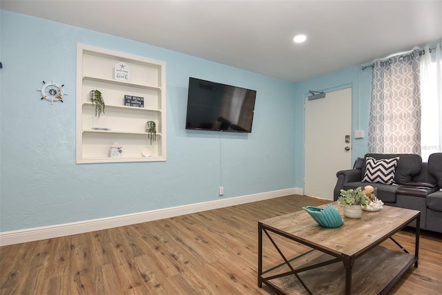 103 Mason Park Dr, Daytona Beach, FL 32117 - living room featuring wood finished floors, baseboards, and built in shelves