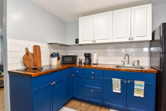 103 Mason Park Dr, Daytona Beach, FL 32117 - kitchen with blue cabinets, wood counters, and black appliances