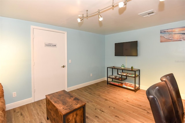 103 Mason Park Dr, Daytona Beach, FL 32117 - living area featuring visible vents, baseboards, track lighting, and wood finished floors