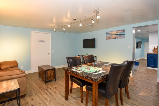 103 Mason Park Dr, Daytona Beach, FL 32117 - dining room with visible vents, baseboards, light wood-type flooring, and rail lighting