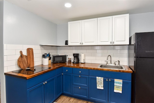 103 Mason Park Dr, Daytona Beach, FL 32117 - kitchen featuring butcher block counters, a sink, black appliances, and blue cabinetry