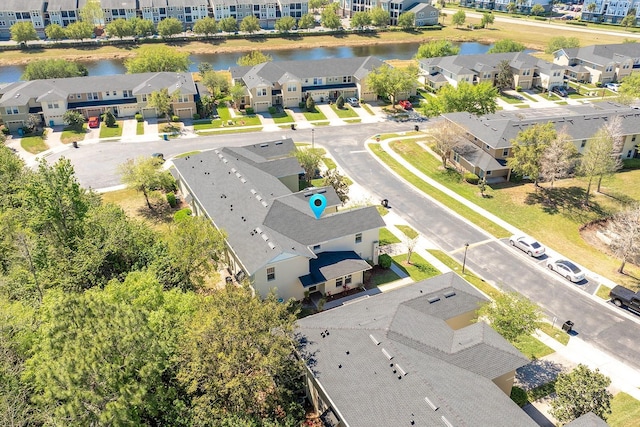 drone / aerial view with a residential view and a water view