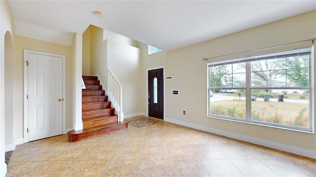 1402 Missouri Pl, Poinciana, FL 34759 - entrance foyer with baseboards, stairs, and light tile patterned floors