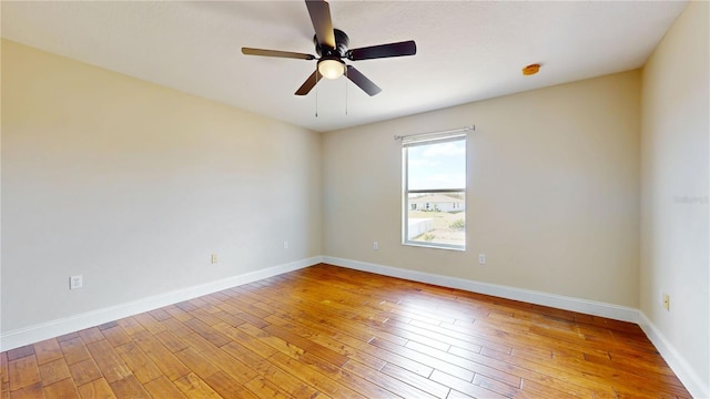 1402 Missouri Pl, Poinciana, FL 34759 - unfurnished room with light wood finished floors, ceiling fan, and baseboards
