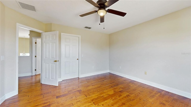1402 Missouri Pl, Poinciana, FL 34759 - spare room featuring light wood-type flooring, ceiling fan, and baseboards