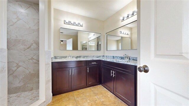 1402 Missouri Pl, Poinciana, FL 34759 - full bathroom with double vanity, tiled shower, and tile patterned flooring
