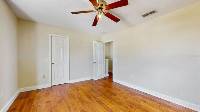 1402 Missouri Pl, Poinciana, FL 34759 - unfurnished bedroom featuring hardwood / wood-style floors, baseboards, and ceiling fan