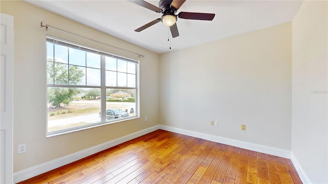 1402 Missouri Pl, Poinciana, FL 34759 - empty room with hardwood / wood-style floors, baseboards, and a ceiling fan
