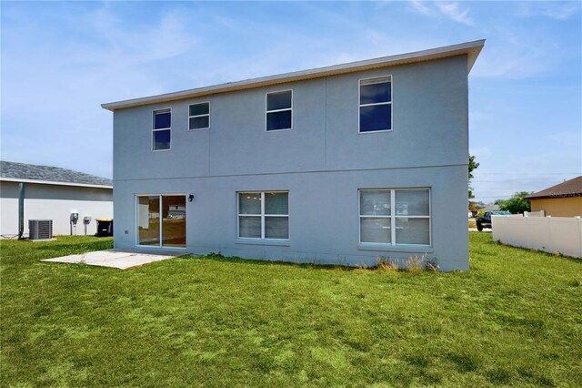 1402 Missouri Pl, Poinciana, FL 34759 - back of house featuring central air condition unit and stucco siding