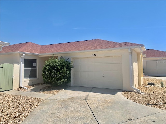 1324 Balboa Ct, The Villages, FL 32159 - ranch-style home with stucco siding, driveway, a shingled roof, and an attached garage