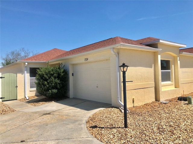 1324 Balboa Ct, The Villages, FL 32159 - view of side of property featuring driveway, stucco siding, and an attached garage