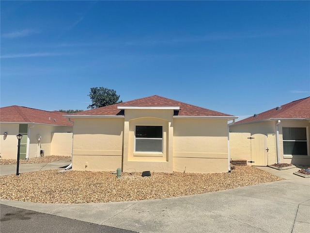 1324 Balboa Ct, The Villages, FL 32159 - mediterranean / spanish-style home featuring a gate, stucco siding, and a shingled roof