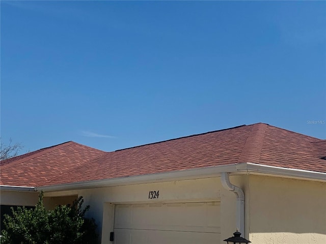 1324 Balboa Ct, The Villages, FL 32159 - exterior details featuring a downspout, stucco siding, gutters, and a shingled roof
