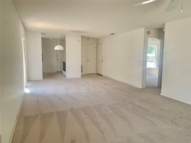 1324 Balboa Ct, The Villages, FL 32159 - empty room with baseboards, a textured ceiling, a ceiling fan, and light carpet
