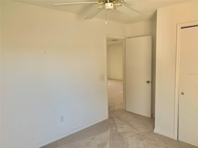 1324 Balboa Ct, The Villages, FL 32159 - unfurnished bedroom with light colored carpet, ceiling fan, baseboards, and a textured ceiling