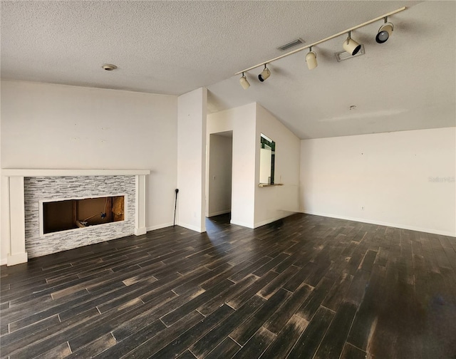 4942 Samoa Cir Unit 5, Orlando, FL 32808 - unfurnished living room with a textured ceiling, visible vents, a tile fireplace, and wood finished floors