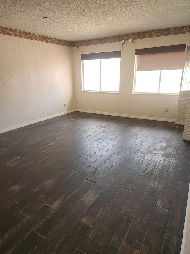 4942 Samoa Cir Unit 5, Orlando, FL 32808 - unfurnished room featuring dark wood-style flooring, baseboards, and a textured ceiling