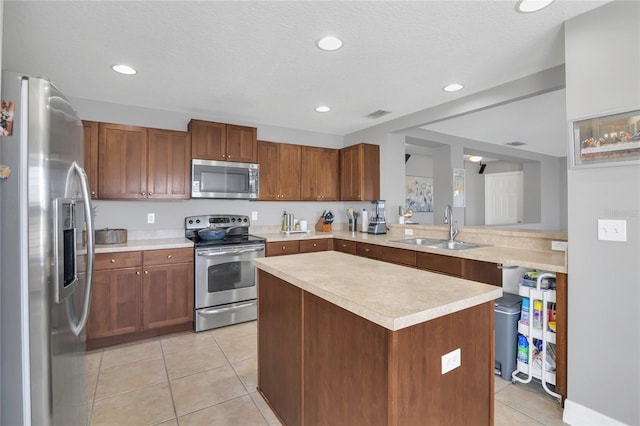 1510 Pier St, Clermont, FL 34711 - kitchen with light tile patterned floors, a sink, appliances with stainless steel finishes, light countertops, and recessed lighting