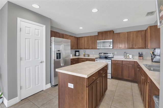 1510 Pier St, Clermont, FL 34711 - kitchen with light tile patterned floors, a sink, stainless steel appliances, and light countertops