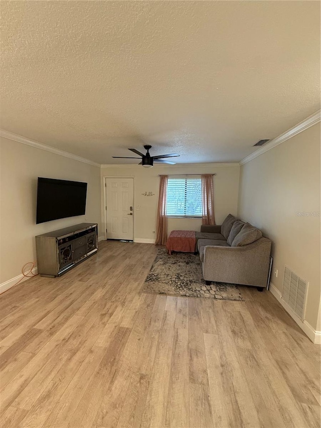 unfurnished living room with a textured ceiling, visible vents, crown molding, wood finished floors, and a ceiling fan