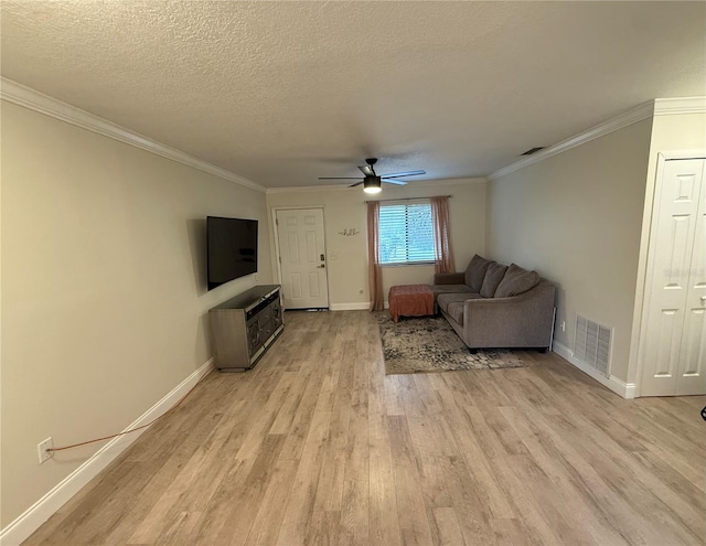 living area featuring visible vents, crown molding, light wood-style floors, and ceiling fan