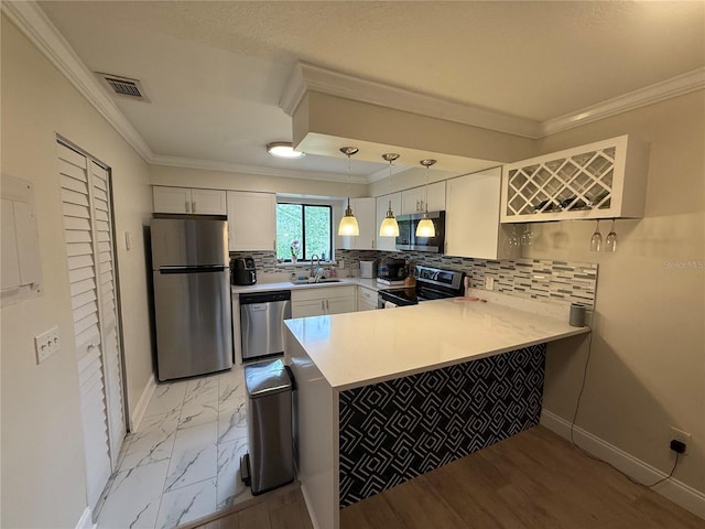 kitchen with a sink, appliances with stainless steel finishes, a peninsula, marble finish floor, and visible vents