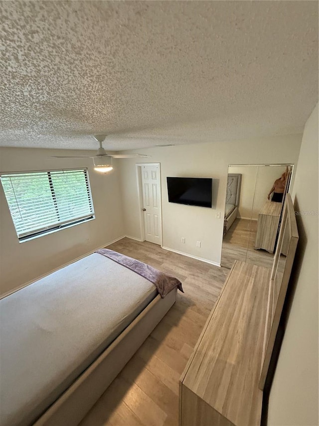 unfurnished bedroom with light wood-style floors and a textured ceiling