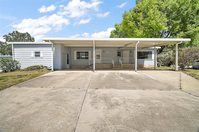 view of front of home featuring driveway and a carport
