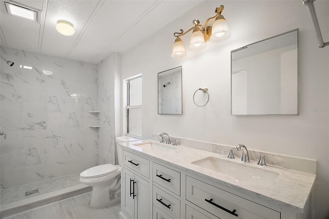 full bath featuring a marble finish shower, marble finish floor, a sink, and toilet