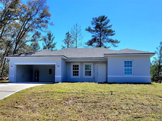 ranch-style home featuring stucco siding, an attached garage, a front lawn, and driveway