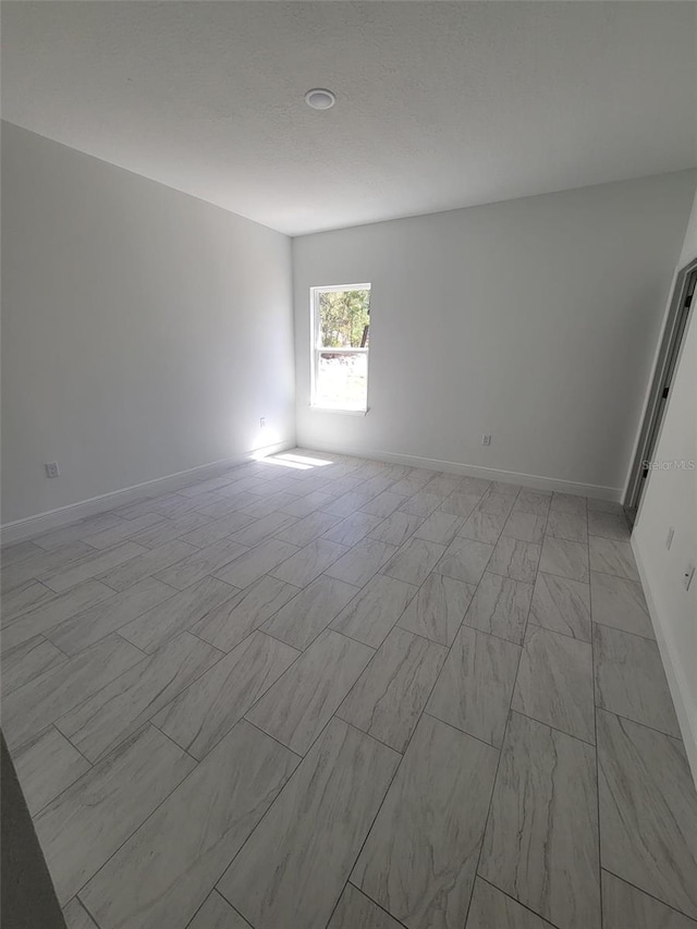 empty room with baseboards