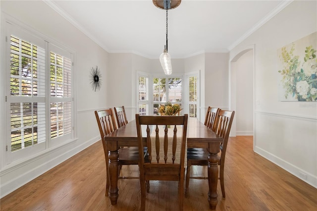 1560 Woodland Ave, Winter Park, FL 32789 - dining space featuring a wealth of natural light, wood finished floors, and crown molding