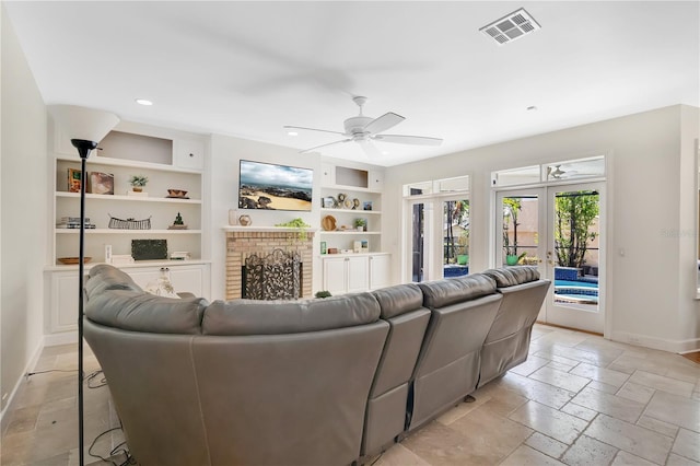 1560 Woodland Ave, Winter Park, FL 32789 - living room featuring visible vents, baseboards, ceiling fan, built in shelves, and stone tile floors
