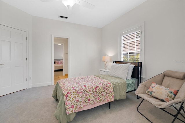 1560 Woodland Ave, Winter Park, FL 32789 - bedroom featuring connected bathroom, light carpet, baseboards, visible vents, and ceiling fan