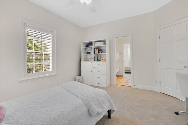 1560 Woodland Ave, Winter Park, FL 32789 - carpeted bedroom with baseboards, ensuite bath, and ceiling fan