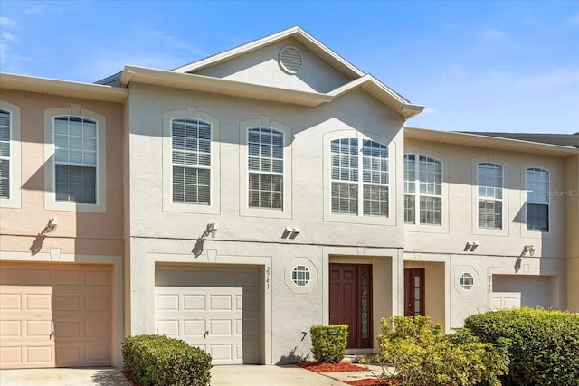 2741 Merrieweather Ln, Kissimmee, FL 34743 - view of property featuring driveway, stucco siding, and a garage