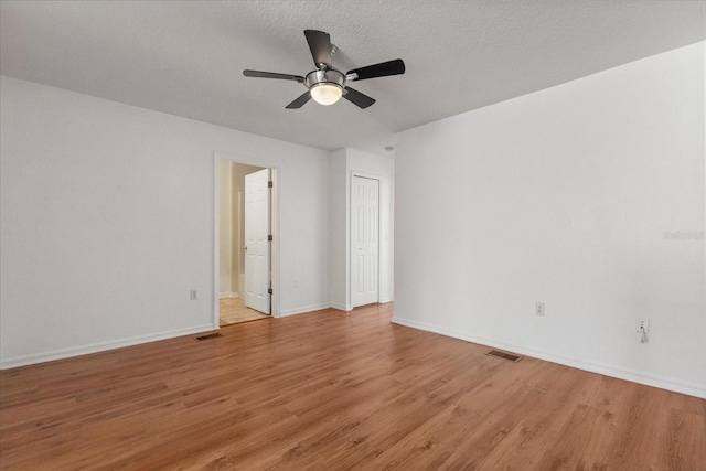 2741 Merrieweather Ln, Kissimmee, FL 34743 - empty room featuring visible vents, light wood-style floors, and a ceiling fan